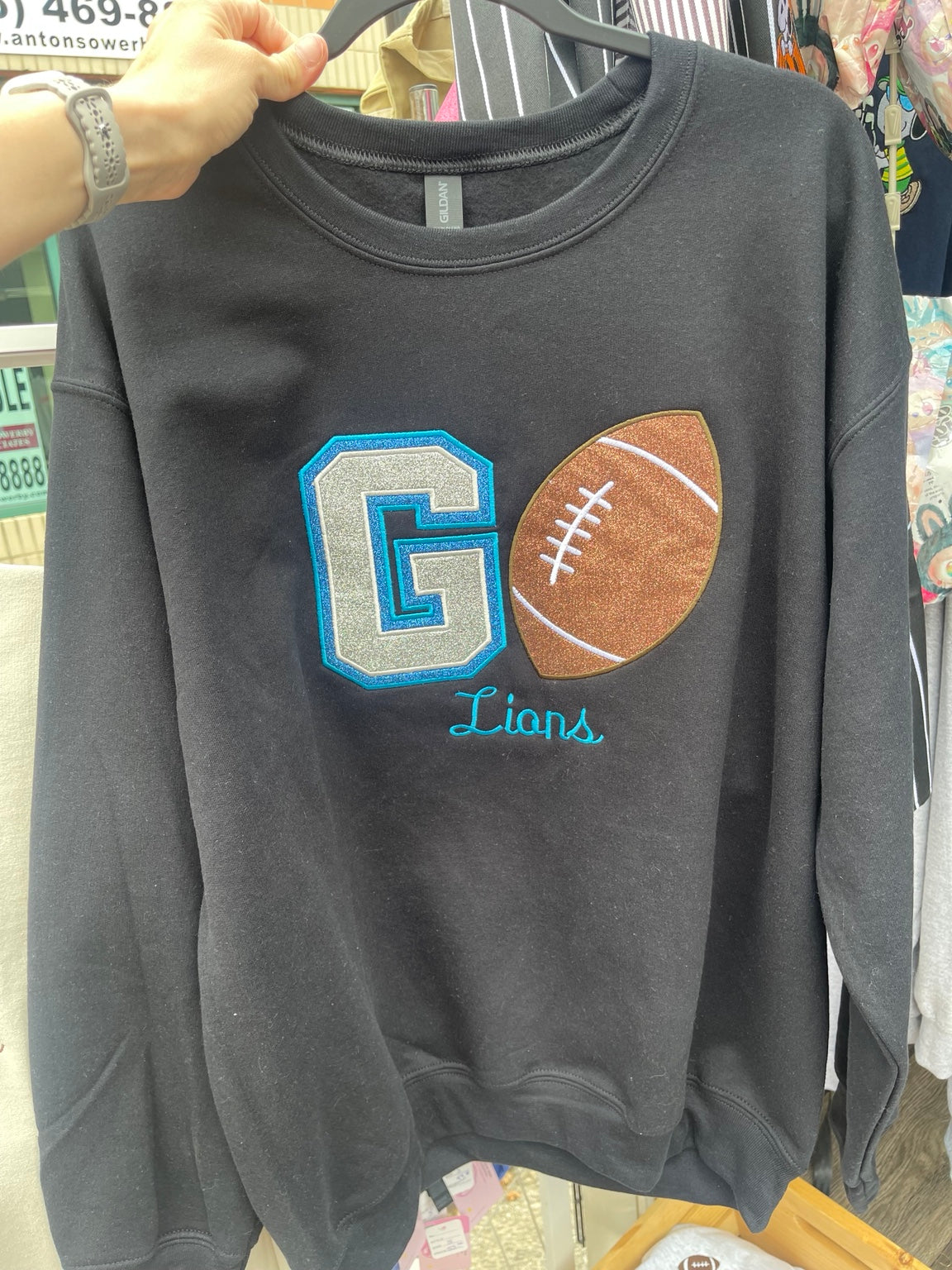 Black Go Lions embroidered crewneck sweatshirt with glitter football design