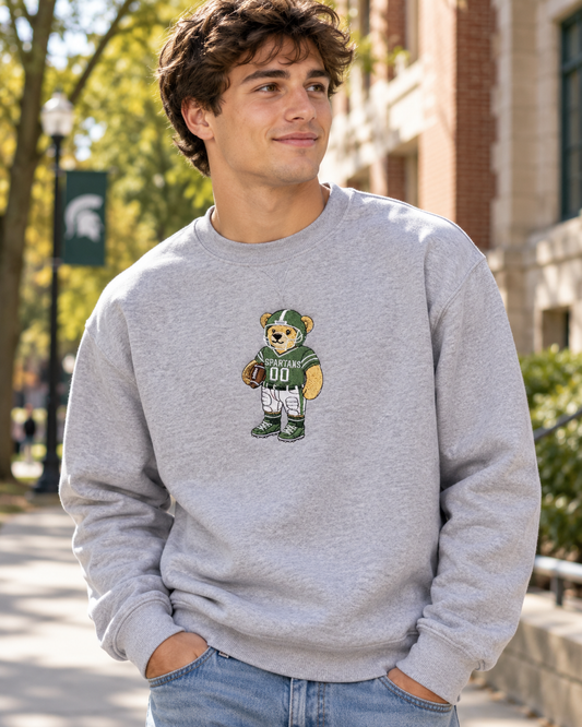 Male model wearing green football teddy embroidered sweatshirt