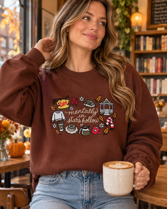 Model wearing brown Small Town Icons embroidered sweatshirt